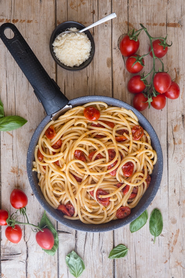 roasted parmesan tomatoes and bucatini pasta in a pan